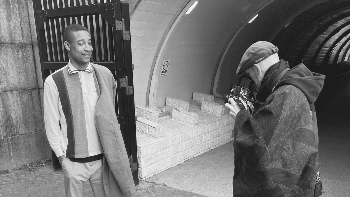 Workshop student photographing a model on a Tokyo street during a portrait photography Tokyo photoshoot session