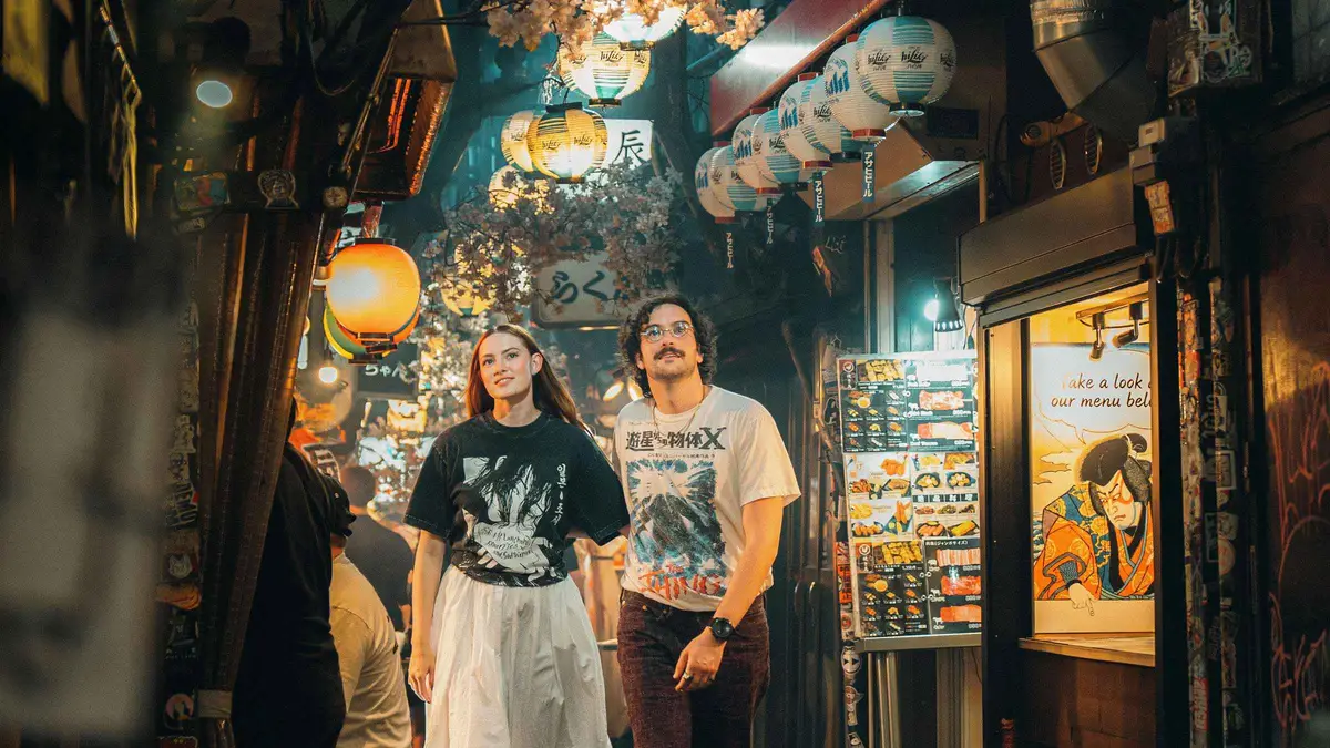 Editorial-style portrait being directed on a Shibuya street during a cinematic Tokyo photoshoot